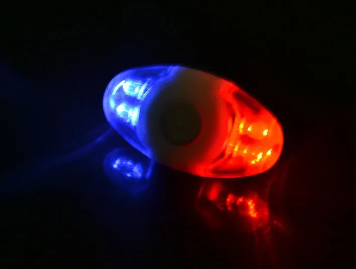 Red and blue LED tail light with adjustable mounting base shown in use.