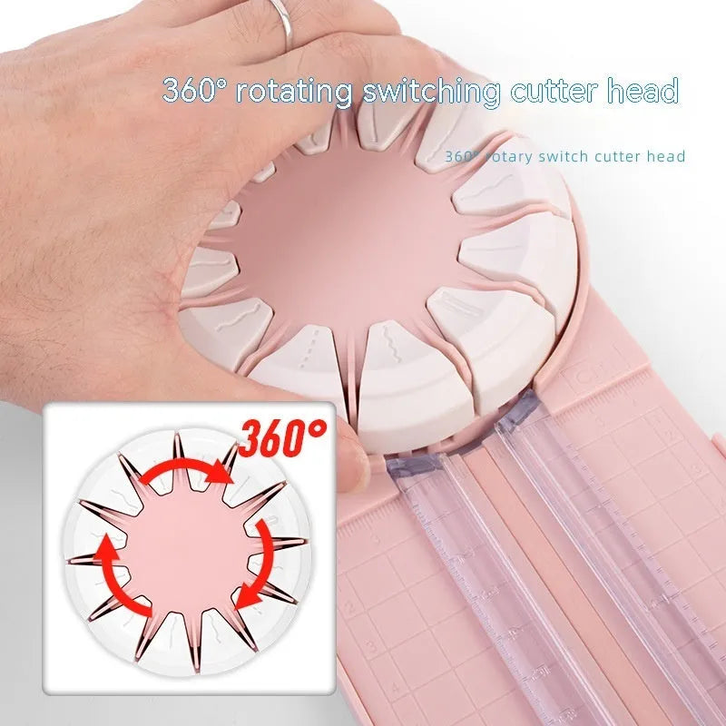 Pink plastic 12-in-1 paper cutting machine with dotted perforation wheel on craft table