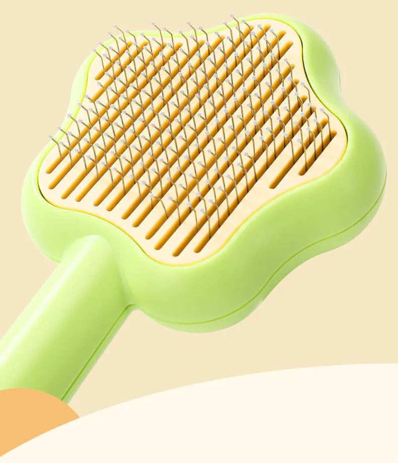 Green pet grooming comb with stainless steel needles and self-cleaning mechanism
