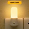 Compact square white minimalist plug-in bedside night light on a surface.