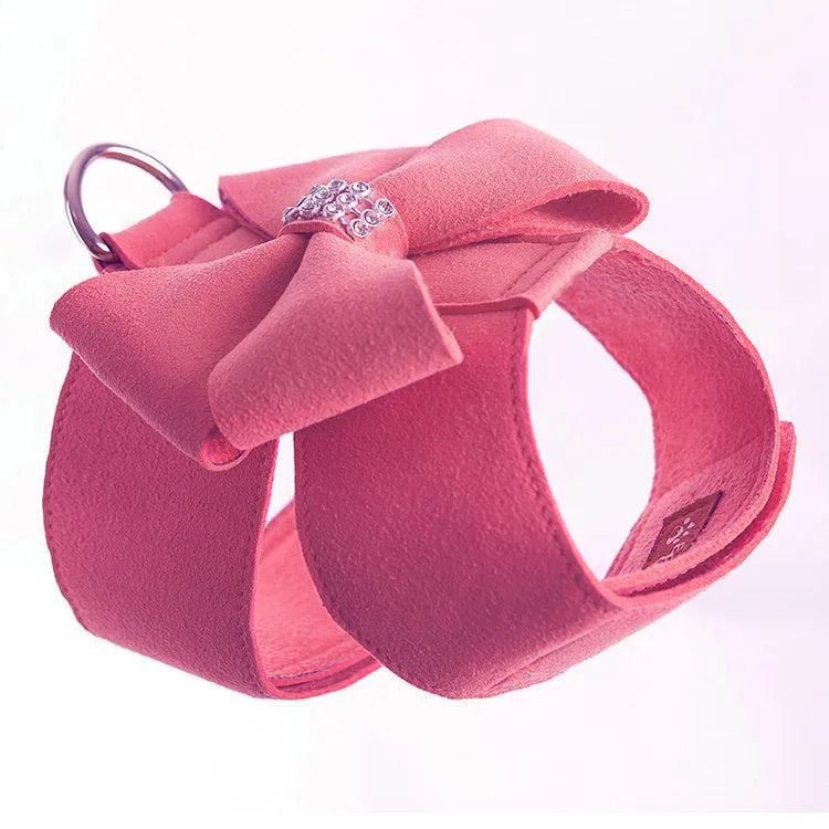 A pink microfiber dog chest strap featuring a sewn-on bowknot shaped like a puppy.