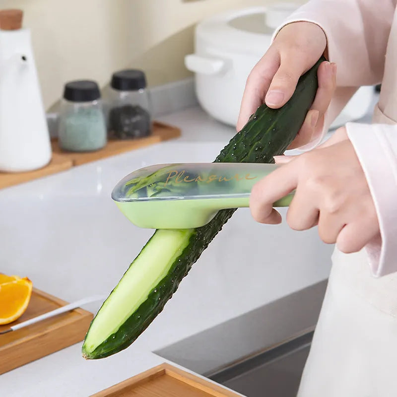 Dark green potato peeler with storage tube, stainless steel blade and plastic handle for kitchen use