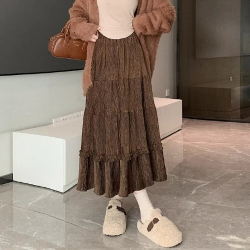 Korean style beige corduroy A-line midi skirt with an elastic waistband on a hanger.