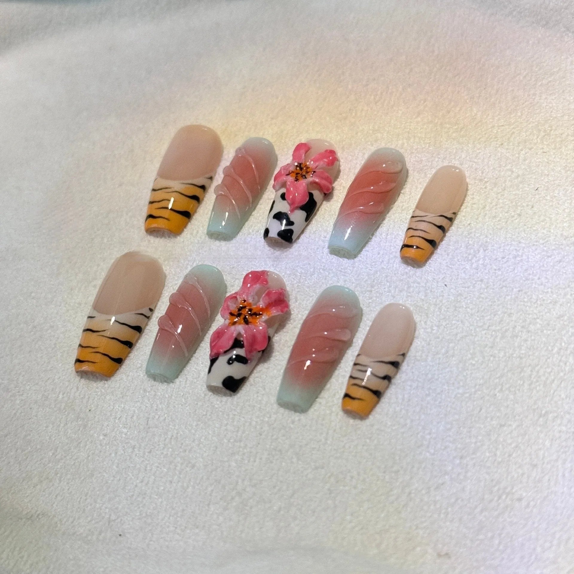 Hand carved zebra pattern nail art with embossed flower and leopard print designs in four size options