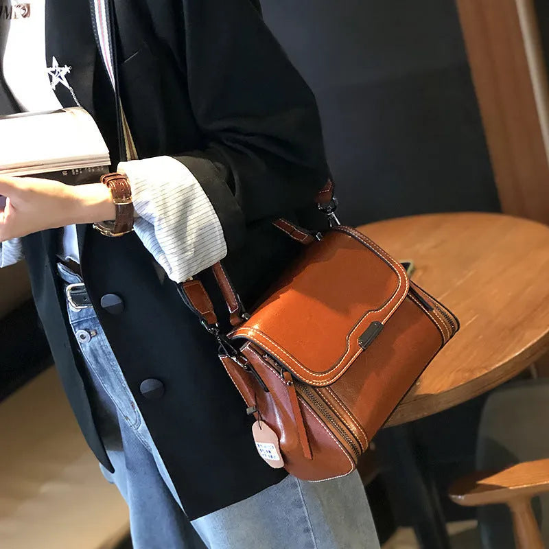 Women's genuine leather messenger bag in retro styling with multiple internal compartments