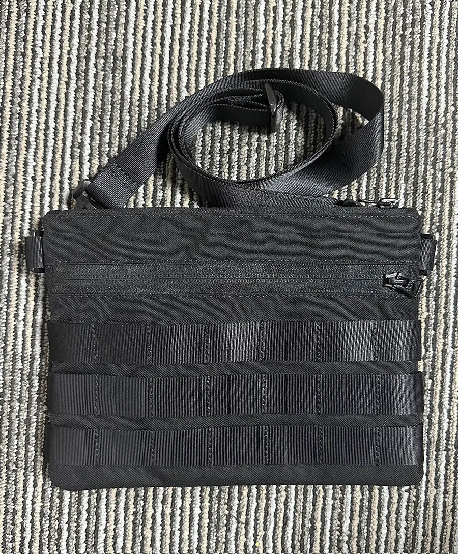 Black military-style Oxford cloth waist bag shown closed, measuring 18cm.