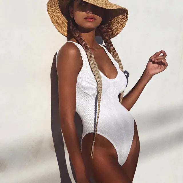 Solid-colour seersucker fabric one-piece swimsuit for women in a backless design.