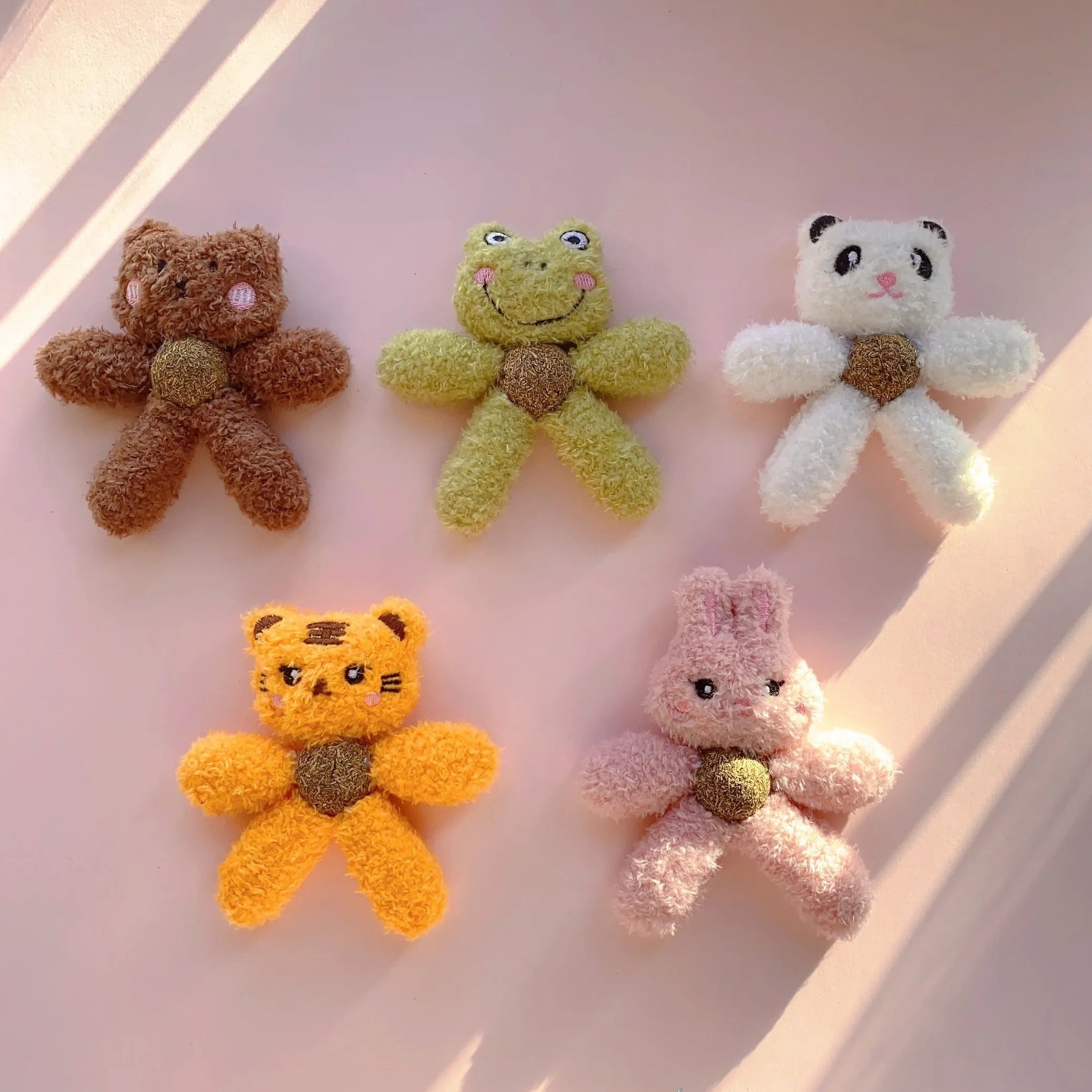 Brown bear shaped stuffed catnip ball edible chewing toy for cats on a white background.