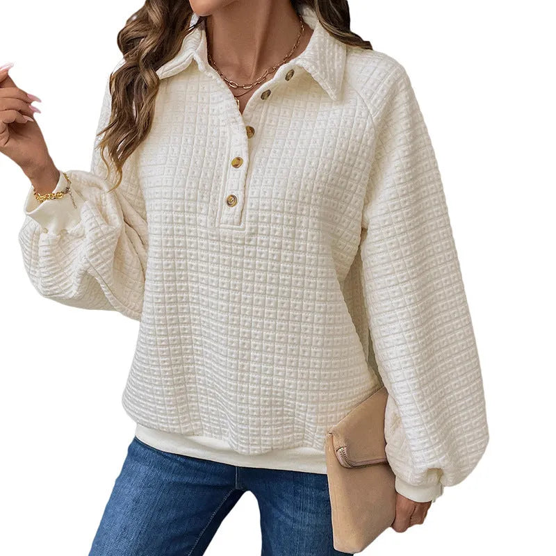 Beige women's knitted sweater with a polo collar and long sleeves laid flat.