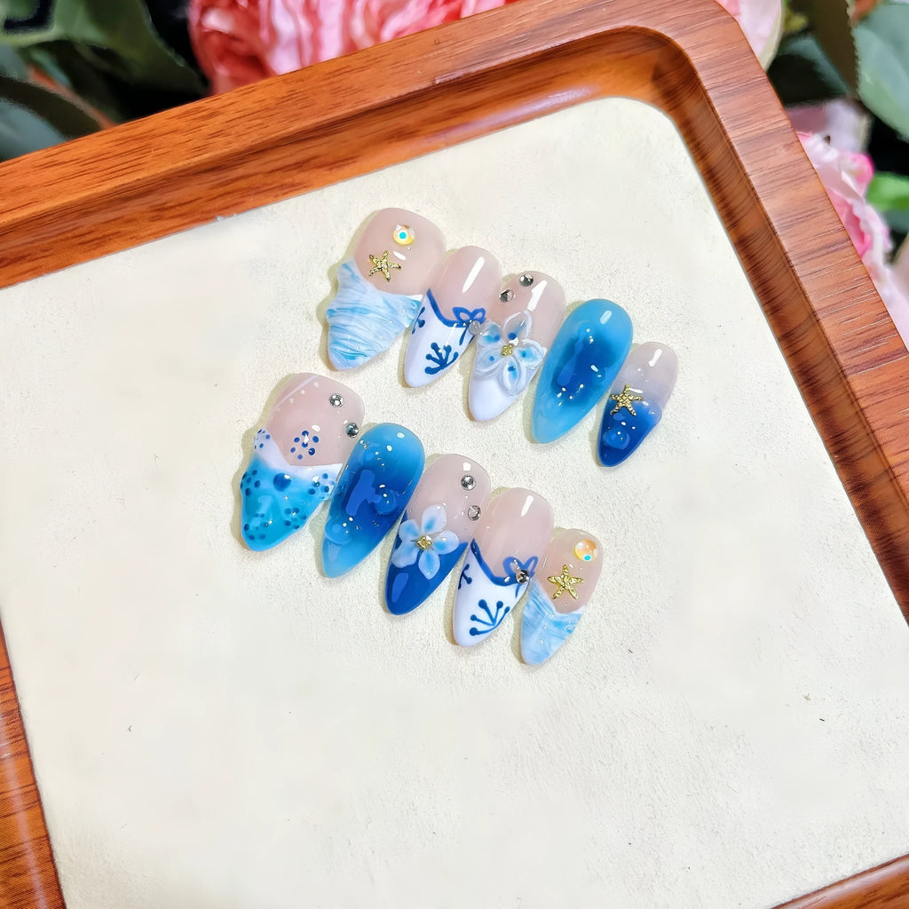 Blue transparent false nails with hand-painted carved summer ice design