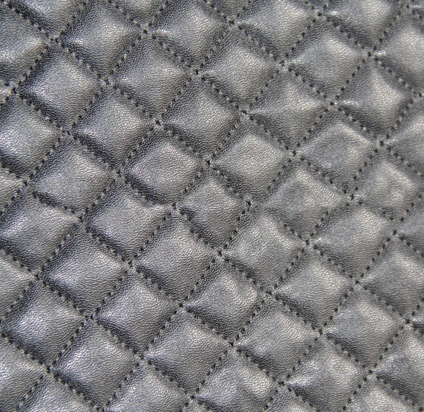 Black quilted automotive seat covers showing PU and polyester fabric construction with plastic hook fasteners