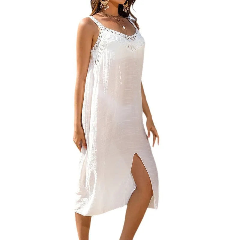 White women's beach dress with suspenders, hollow crochet weaving detail, and a bottom slit.