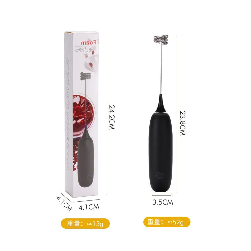 Black and white handheld electric milk frother with whisk attachment for coffee drinks
