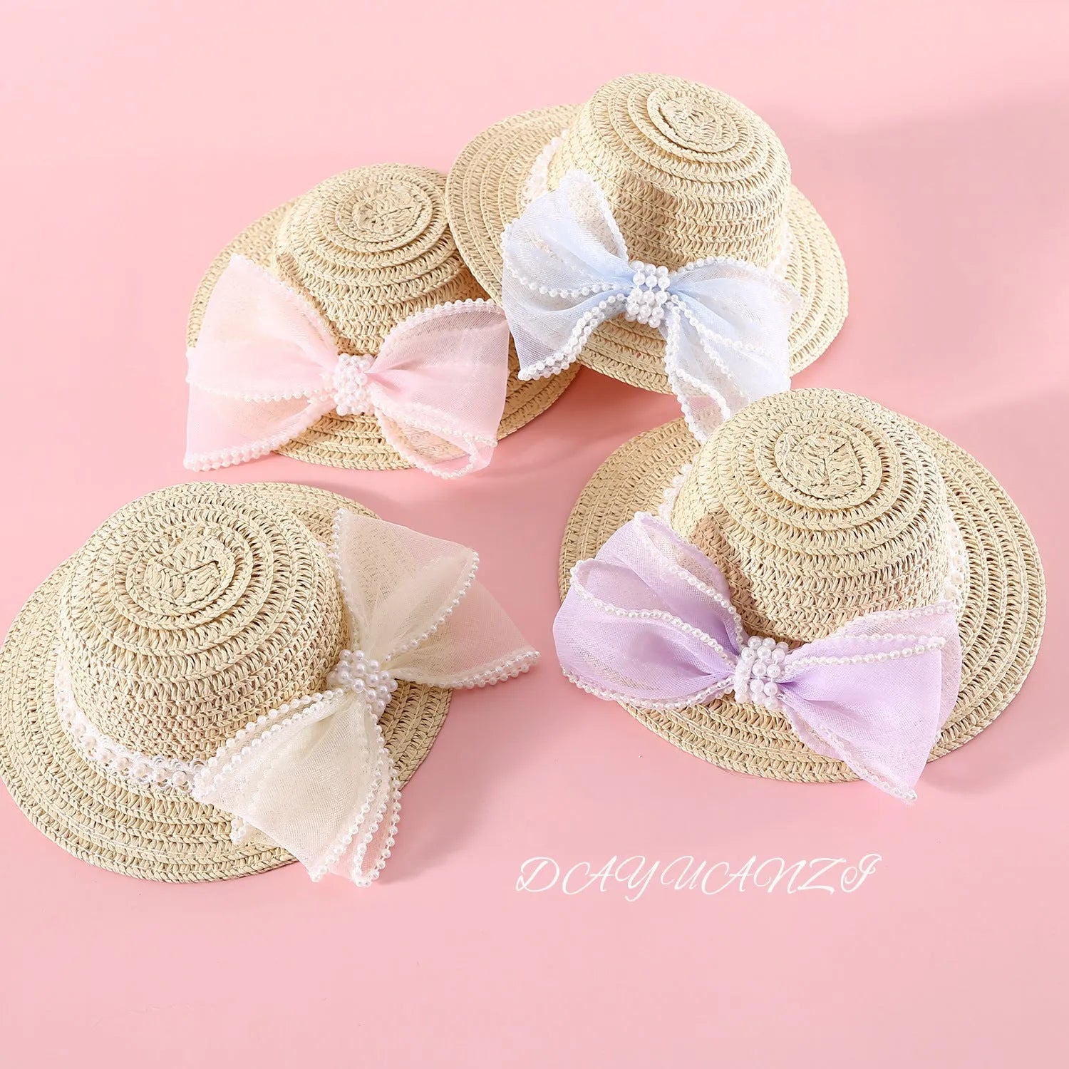 Cat wearing a woven Lafite leaves straw hat with a blue pearl butterfly bow.