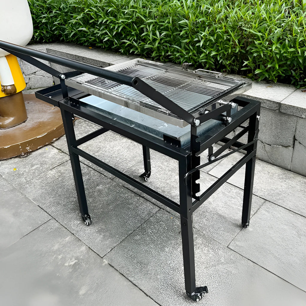 Large foldable charcoal BBQ grill with detachable parts in a garden setting