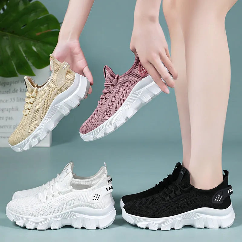 Women's white Flyknit sneakers with a thick PVC sole and lace-up front.