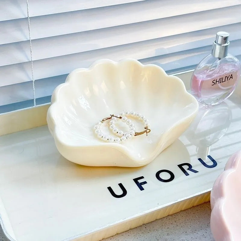 White shell-shaped plastic soap dish for bathroom counter
