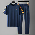 Men's blue polyester sports suit set with short sleeve top and matching trousers
