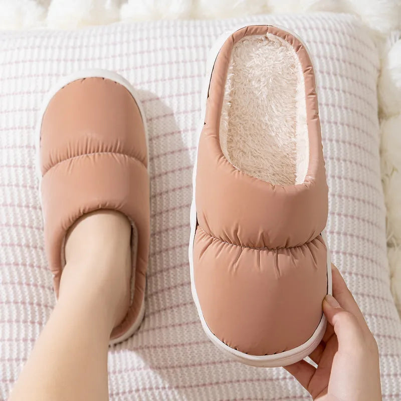 A pair of down cotton slippers with an artificial leather upper and thick rubber sole, shown in blue.