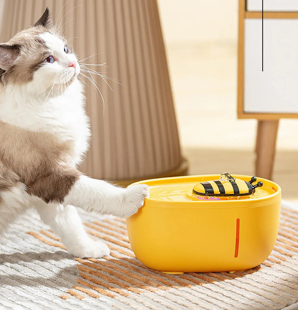 Yellow automatic cat water fountain with filtration system and blue LED light
