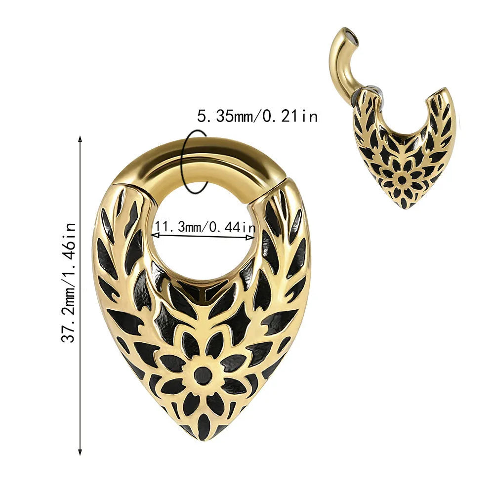 Stainless steel drop-shaped ear extender with totem design on a grey background.