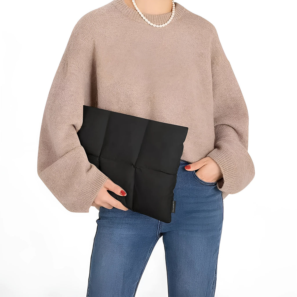 Soft fluffy black polyester laptop sleeve for a 15.6 inch laptop with visible stitching.