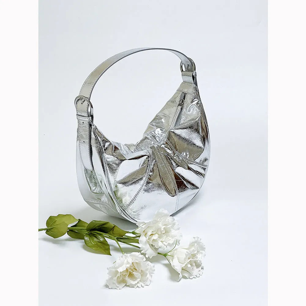 Women's soft cowhide leather shoulder bag in dumpling shape showing double straps and sandwich pocket.