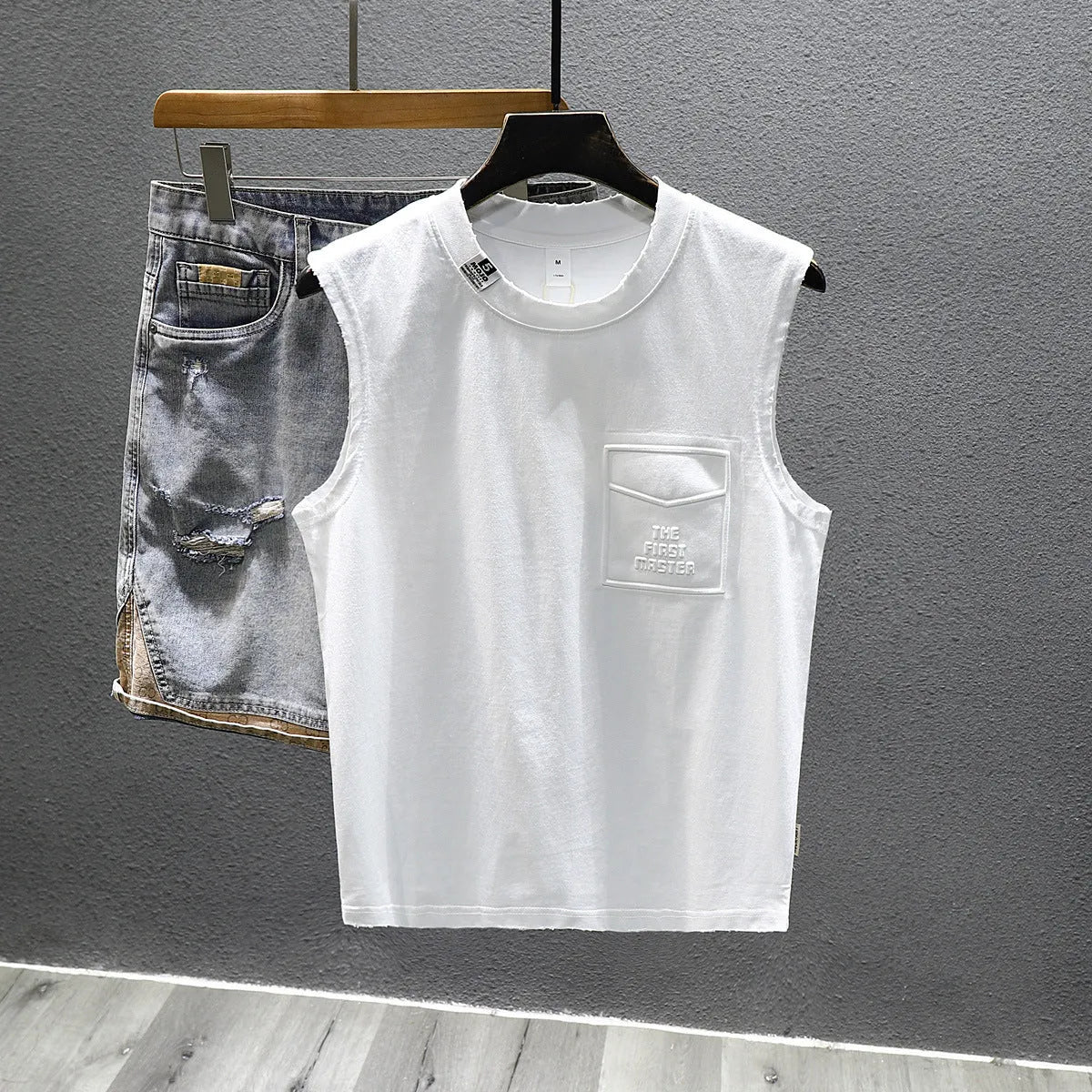 Men's solid colour loose fit cotton sleeveless t-shirt on a hanger