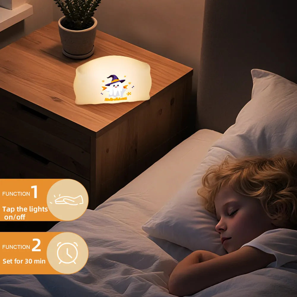 Cartoon ghost doll USB-C rechargeable table lamp in magic ghost or pumpkin ghost colour on a bedside table.