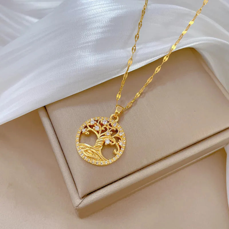Gold-plated cross necklace with rhinestone lucky tree pendant and mother pearl detail on adjustable 41-50cm chain