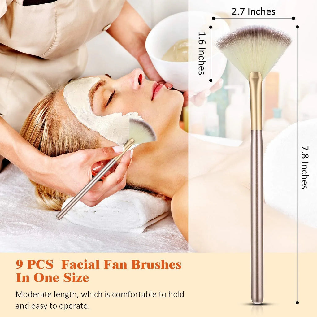 Set of 10 professional facial fan brushes with champagne finish and acrylic handles on a table.