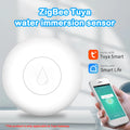 Compact white Zigbee wireless water leak sensor with CR2032 battery on a wooden surface