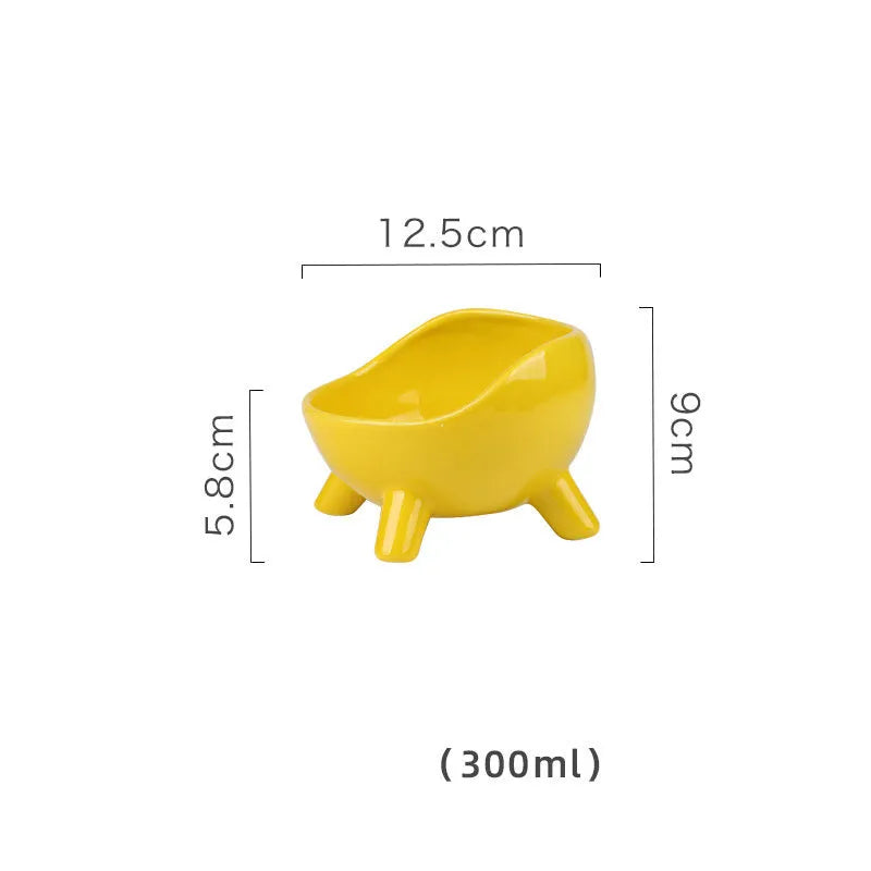 Green ceramic pet food bowl with four legs and a wide, rounded opening.