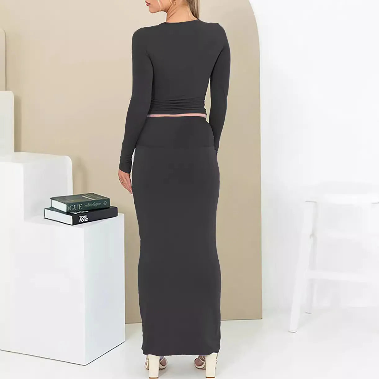 Women's black slim fit polyester two-piece suit with three-quarter sleeves and a long skirt.