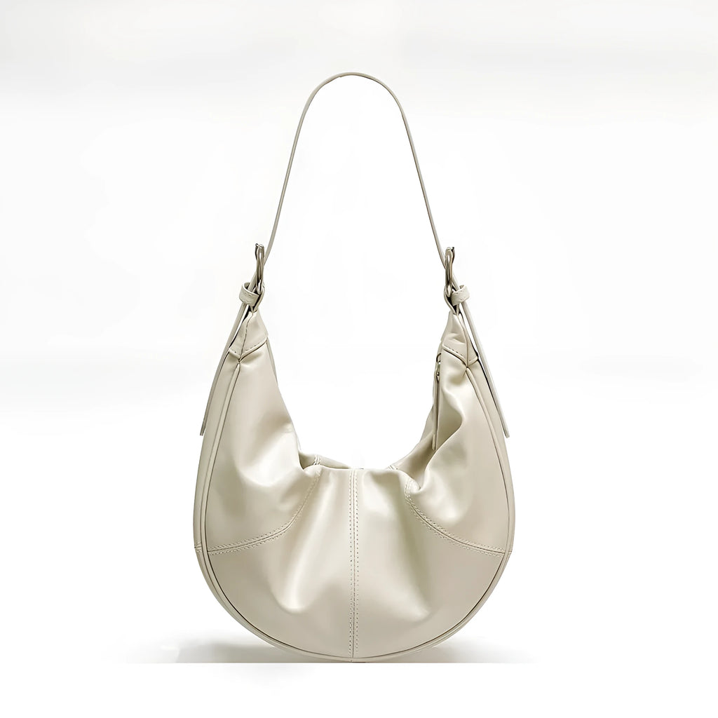 Women's soft cowhide leather shoulder bag in dumpling shape showing double straps and sandwich pocket.