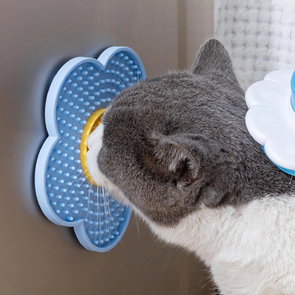 Flower-shaped blue silicone pet lick mat with suction cups on a smooth surface