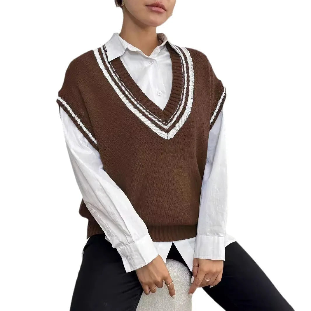 Women's loose fit college style wool vest sweater in blue, laid flat.