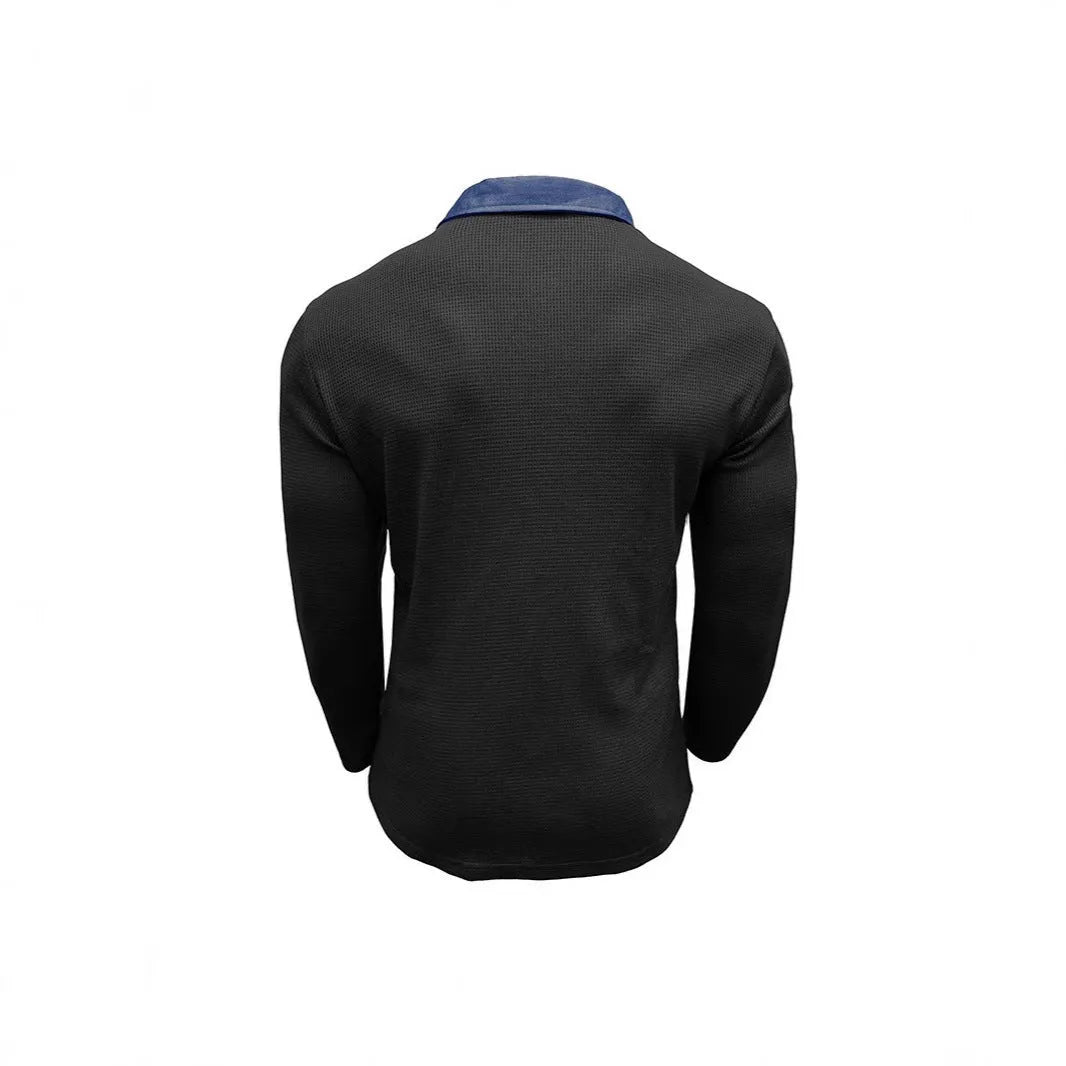 Man wearing a long-sleeved waffle knit polo shirt in a loose, retro style.