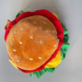 Soft fabric burger-shaped headdress collar for a cat, with adjustable neck straps.
