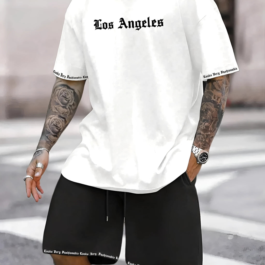 Man wearing a grey short-sleeve top and matching shorts from a sports co-ord set.