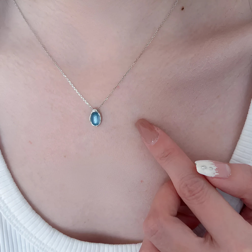 Navy blue water drop necklace with geometric pendant on cross chain, adjustable length jewellery