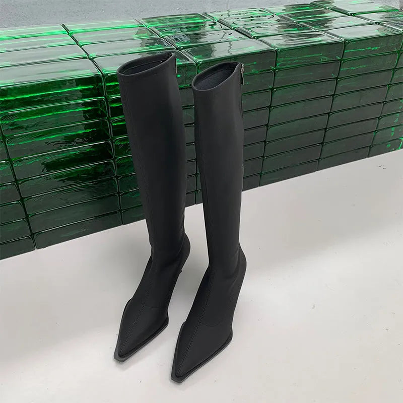 Black women's pointed toe below-the-knee boots with a stiletto heel and a back zipper closure on the side.