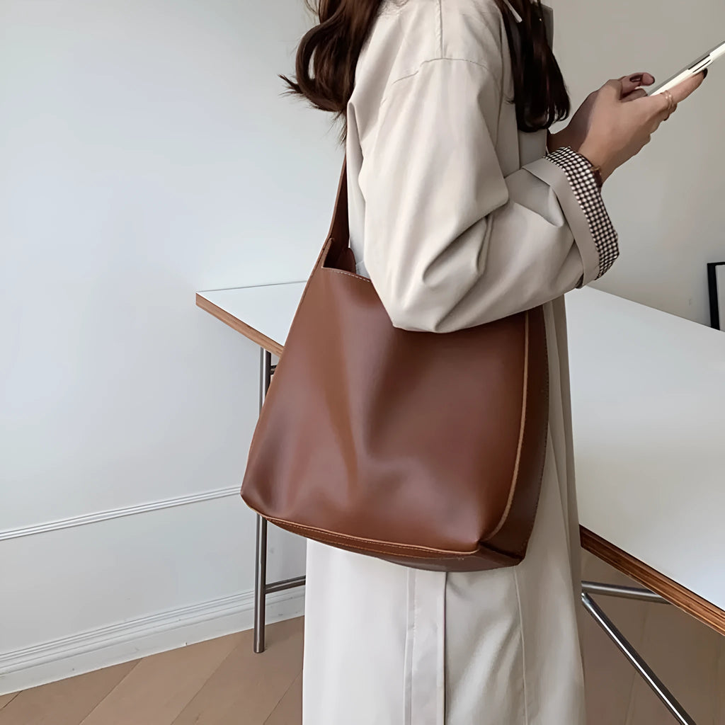 Women's soft PU leather shoulder bag with decorative swing threads in black or brown colour options