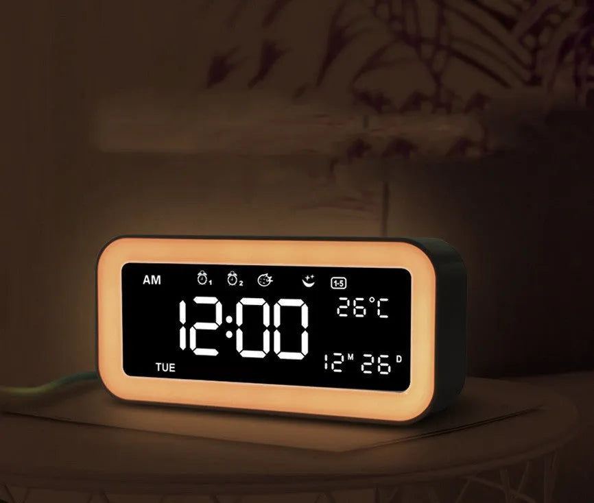 Blue rectangular LED atmosphere alarm clock with digital display on a desk.