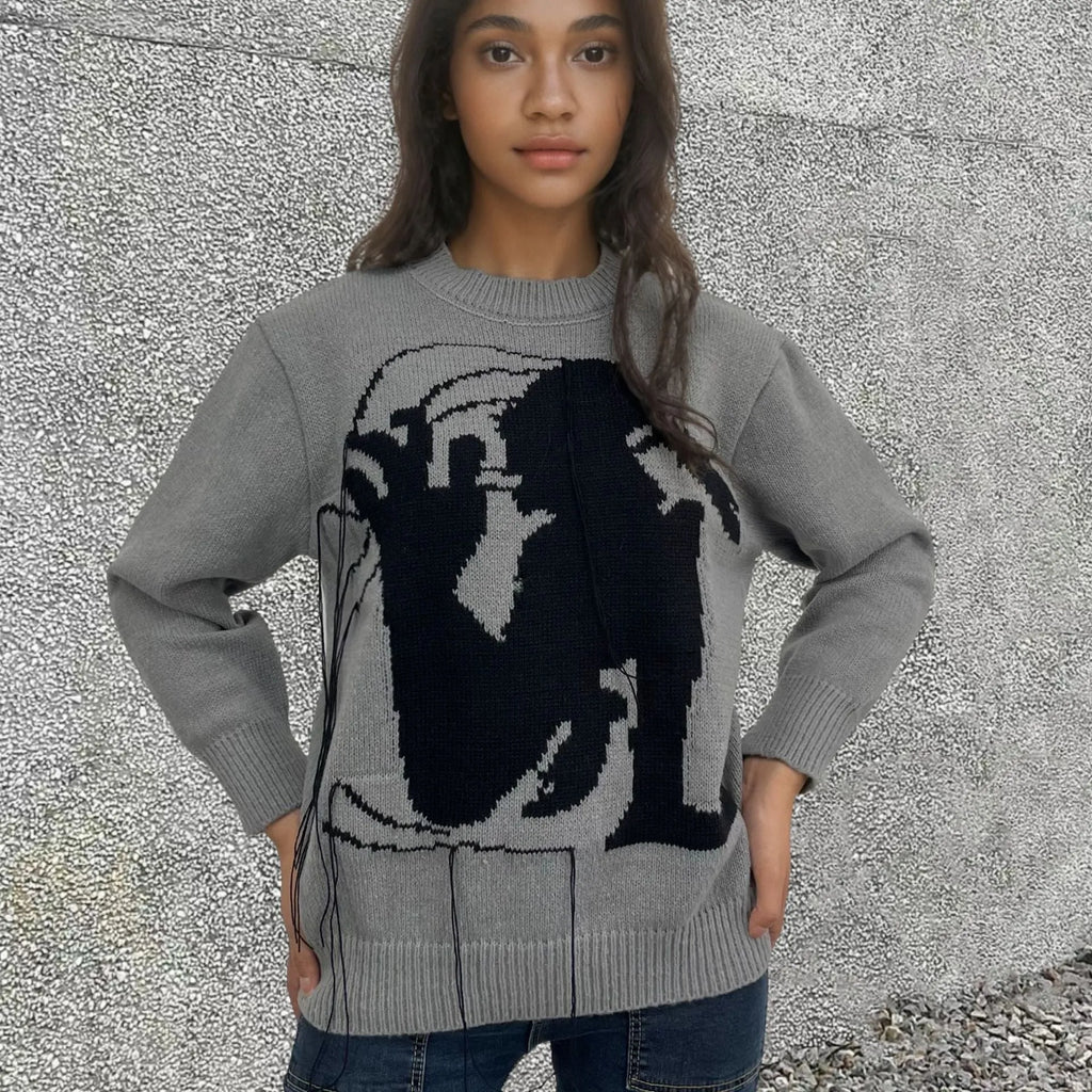 Women's loose grey alpaca wool sweater with tassel detailing and abstract pattern