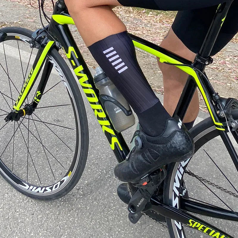 Athletic sports socks for cycling and running in six colour options including orange, black, and purple.