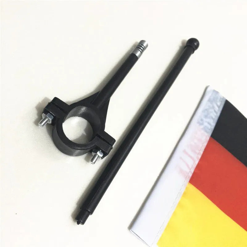 Square polyester cycling flag on a plastic pole mounted on bicycle handlebars.