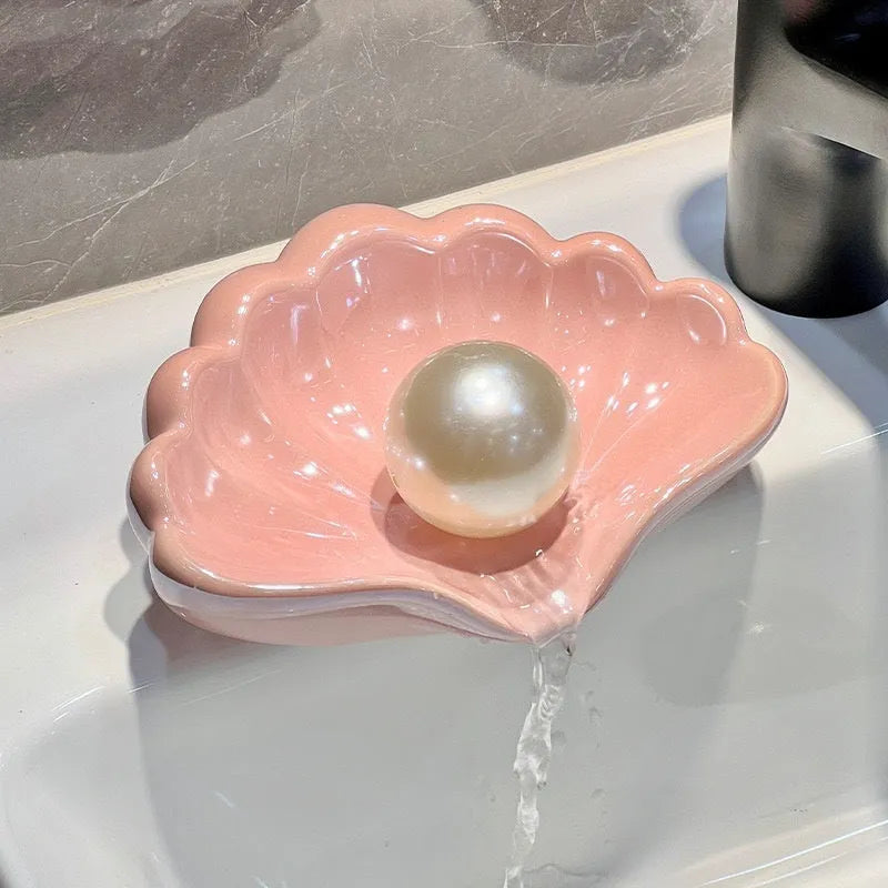 White shell-shaped plastic soap dish for bathroom counter