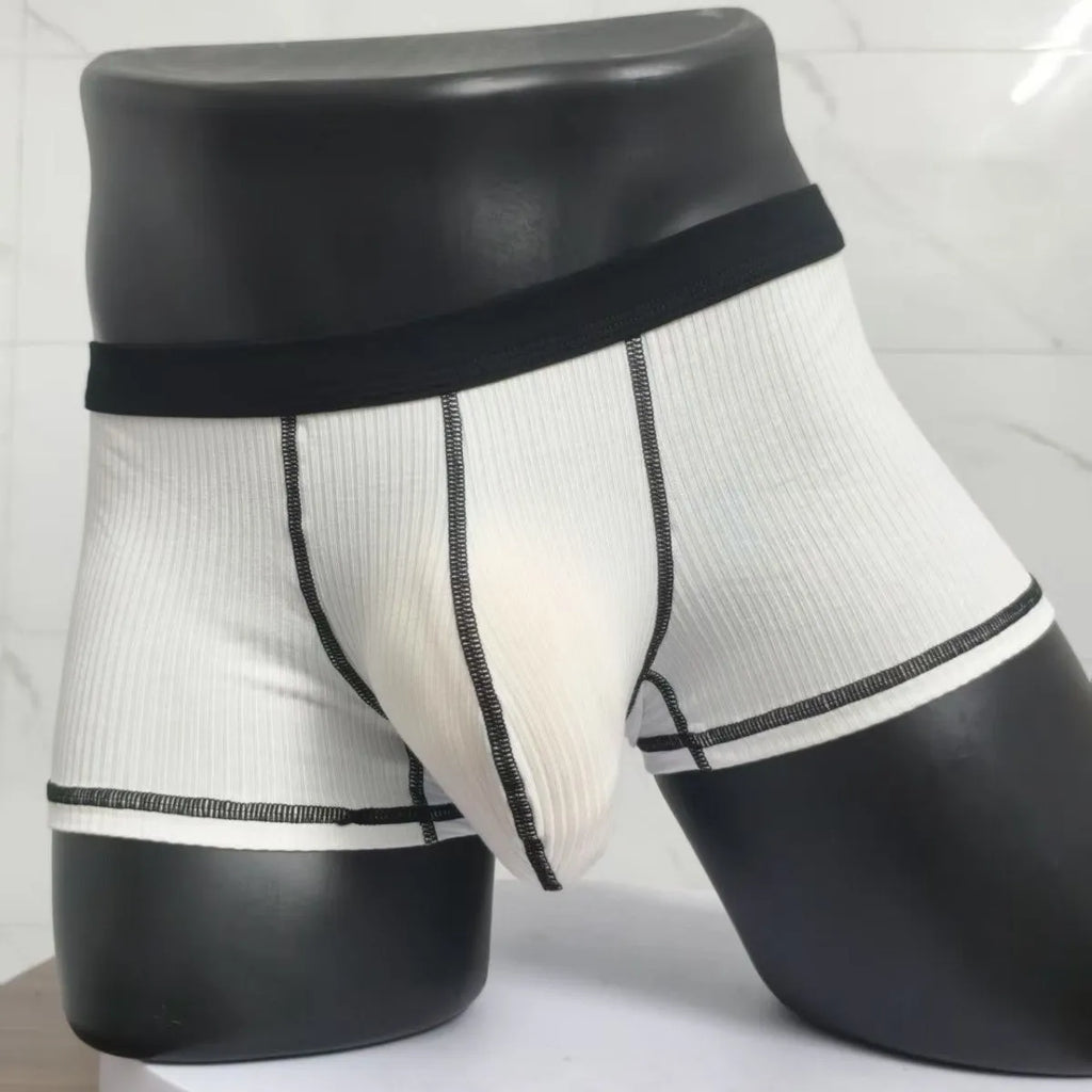 Men's solid-colour fibre boxer shorts on a white background showing hip-lifting design.
