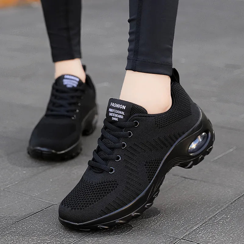 Red and black women's low-top mesh sneakers with round toe and front lace-up.